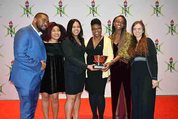 student group accepting award at conference